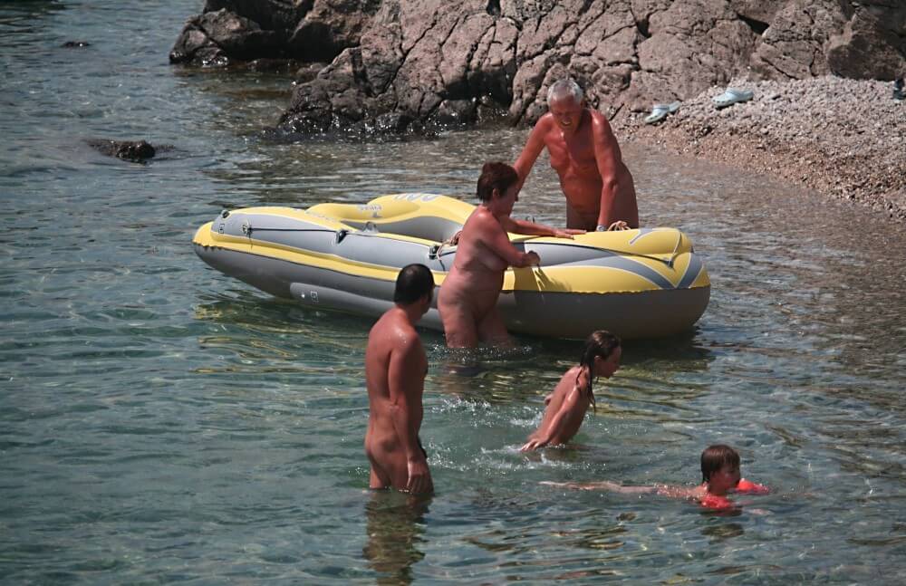 Lone Nudist in Yellow Boat photos - Nudists and naturists: whats the difference?