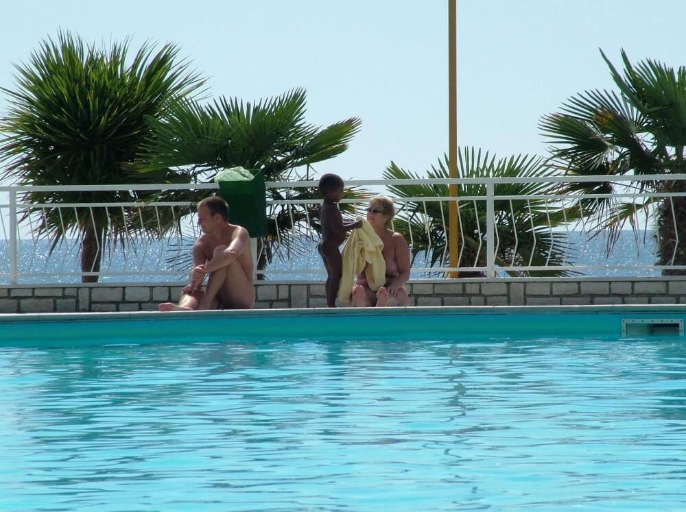 Photo of naturists in an outdoor pool - A Base for Naturist Recreation